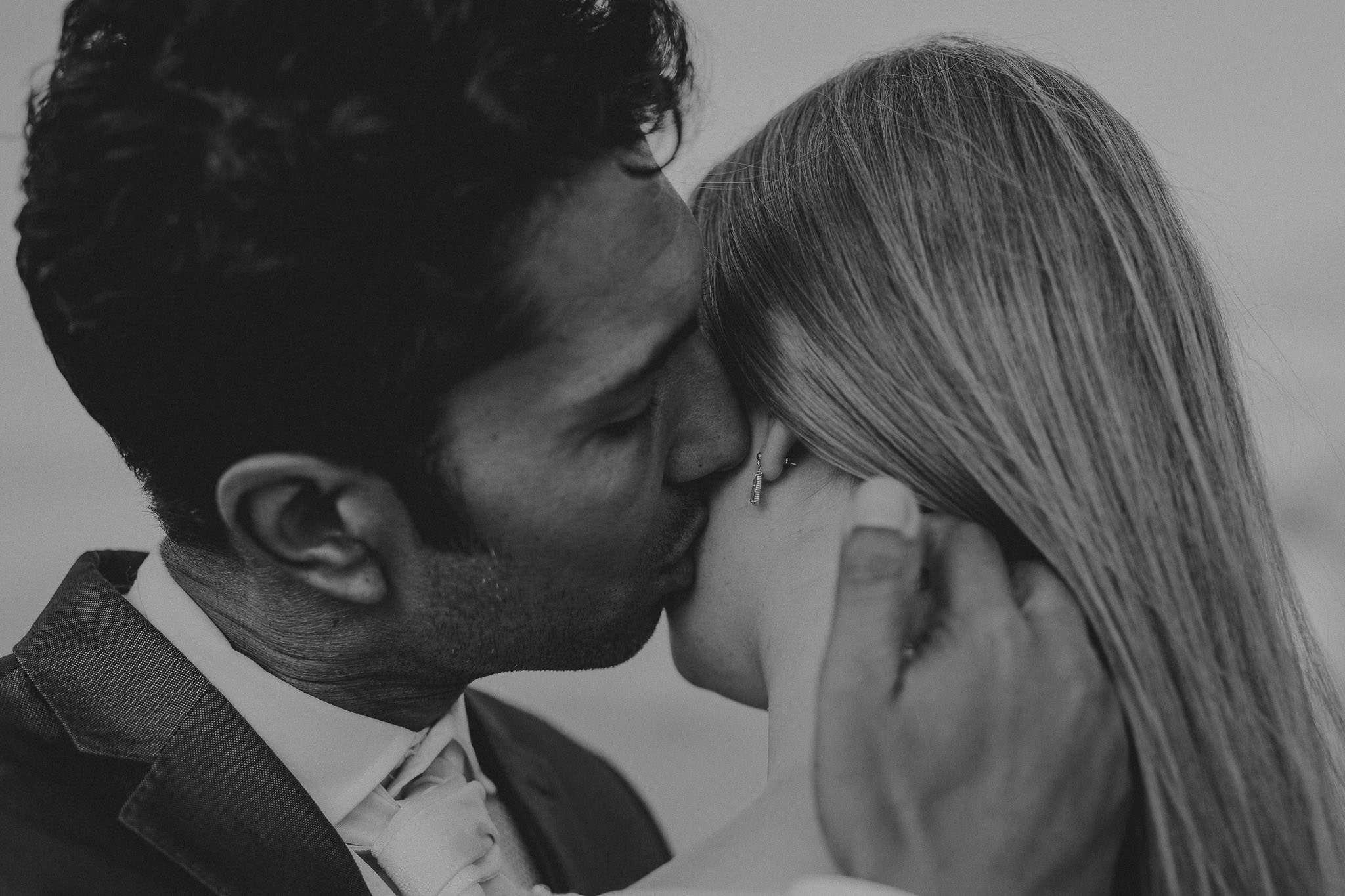 groom kissing bride in Spain