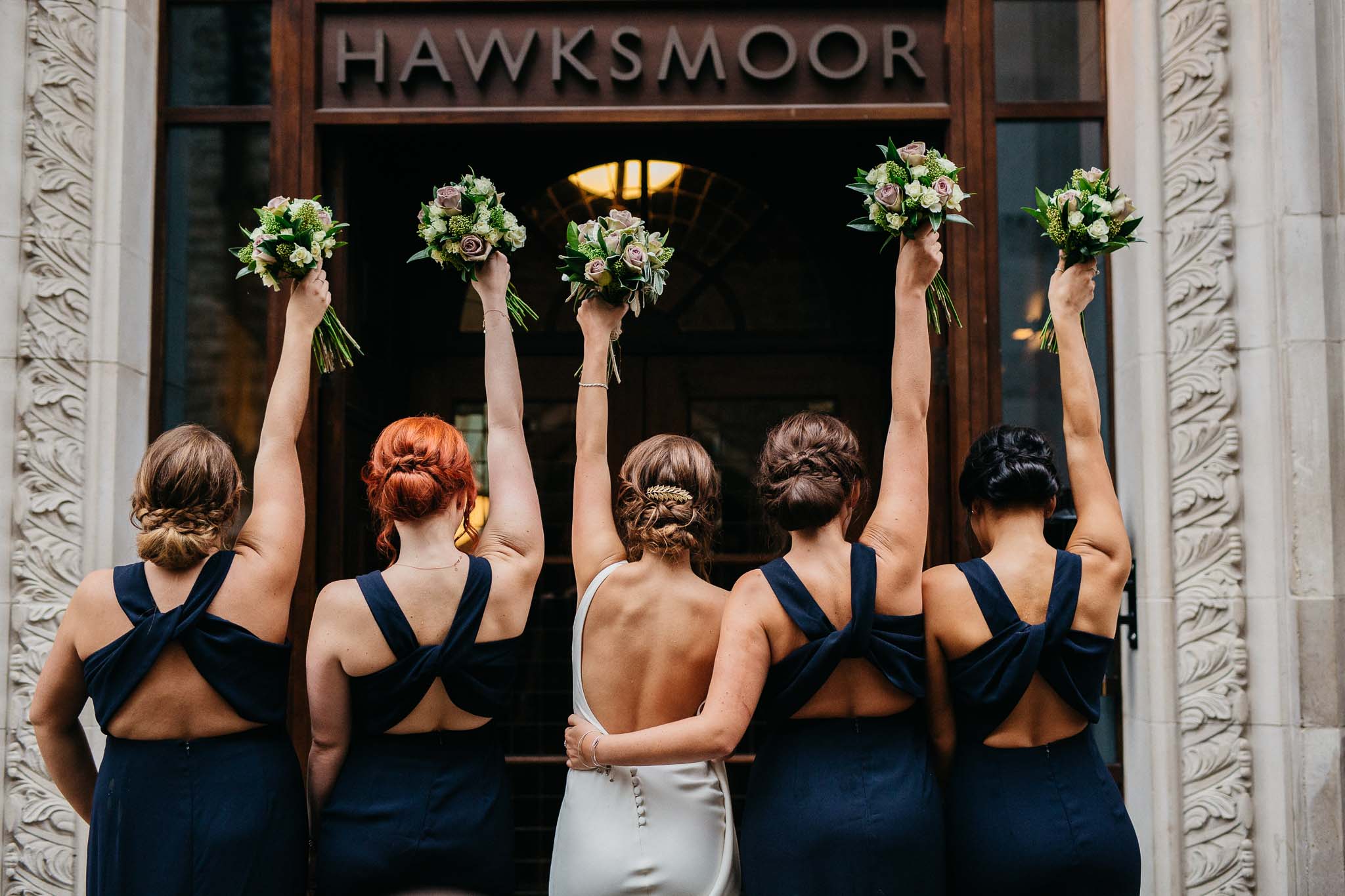 Bride and bridesmaids holding flowers in London